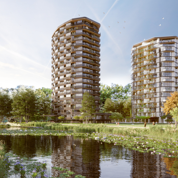 Twee flats in een groene omgeving met een sloot op de voorgrond en bomen aan de rechterzijde